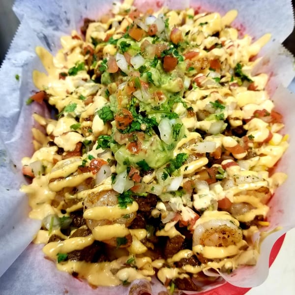 Fuego Mexican Kitchen's loaded fries with shrimp, cheese sauce, guacamole, and pico de gallo.